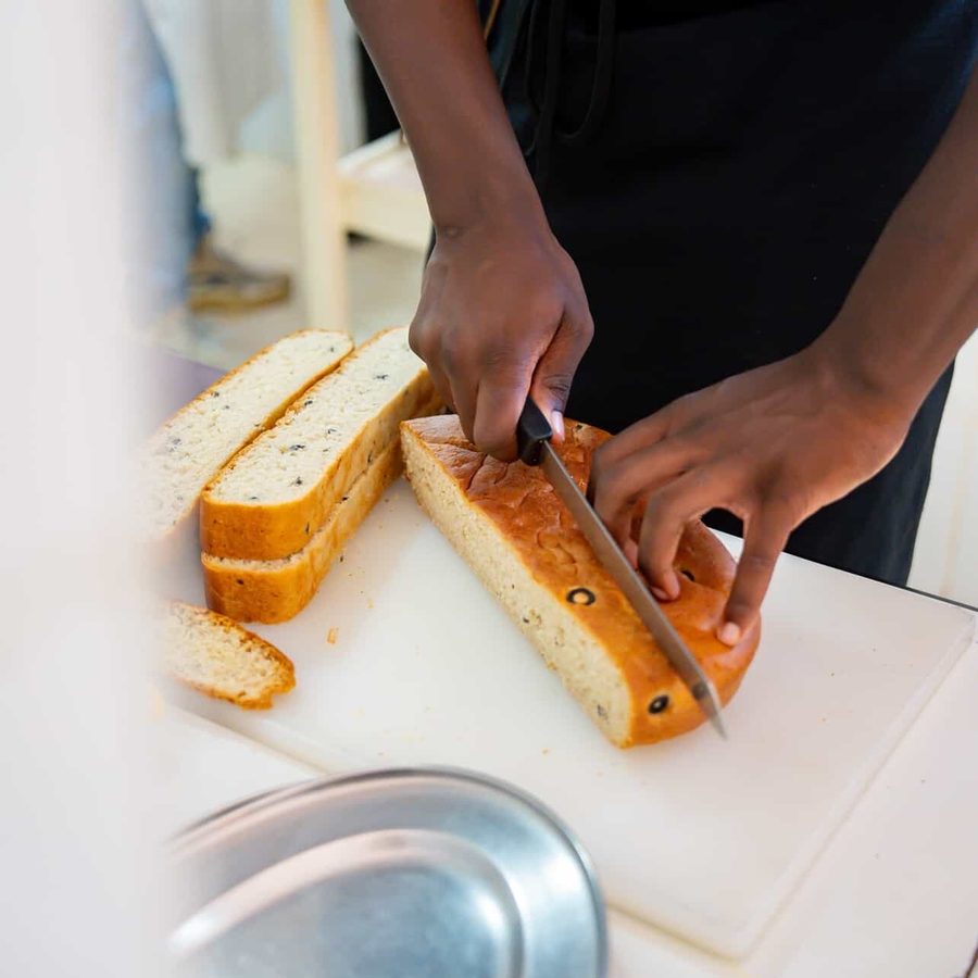 Slicing a fresh-baked olive loaf