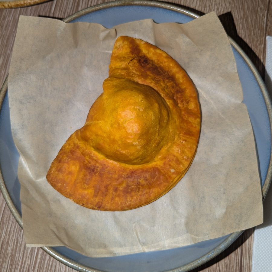 Golden fried empanada on parchment